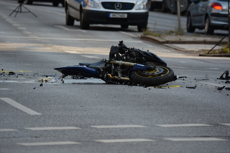 Crashed motorcycle in the middle of the road.