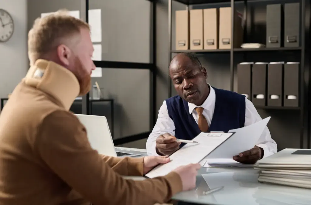 An attorney showing papers to their injured client.