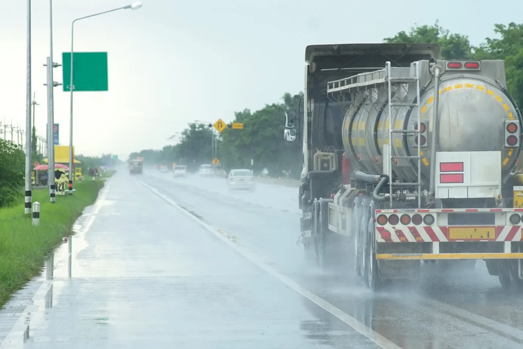 Tanker truck driving in rain.