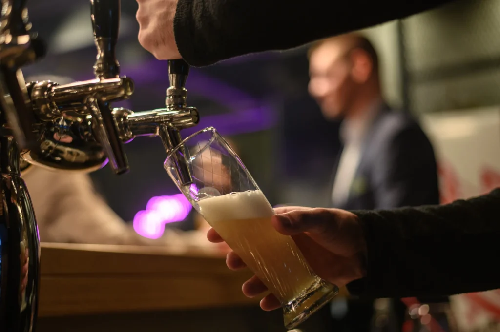 Bartender filling a glass of beer.