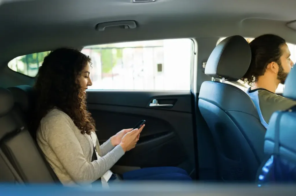 woman on back seat taking a rideshare