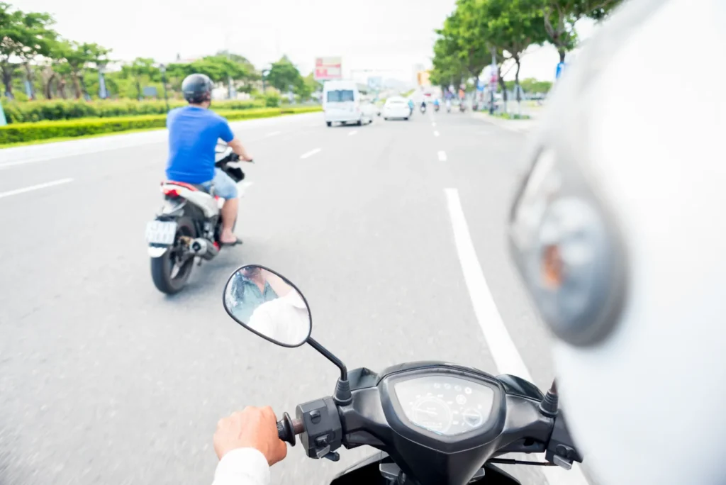 Motorcyclists riding in traffic with a rear view from a scooter, illustrating the risks of rear-end motorcycle accidents in San Antonio.